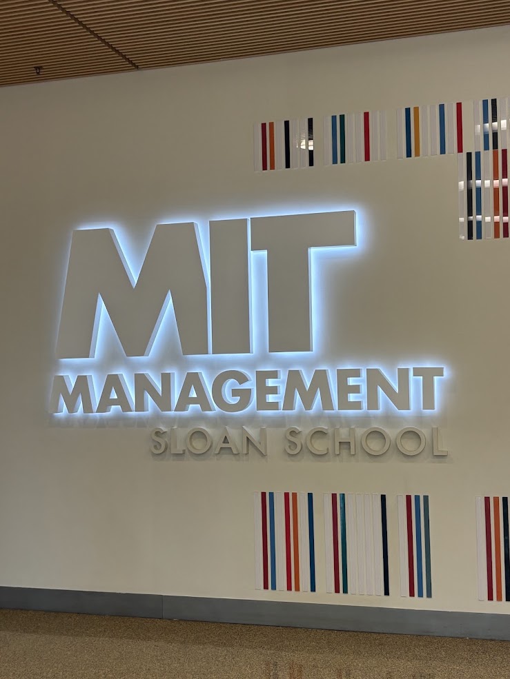 The MIT Sloan School of Management sign in the lobby of the executive education building in Cambridge, Massachusetts